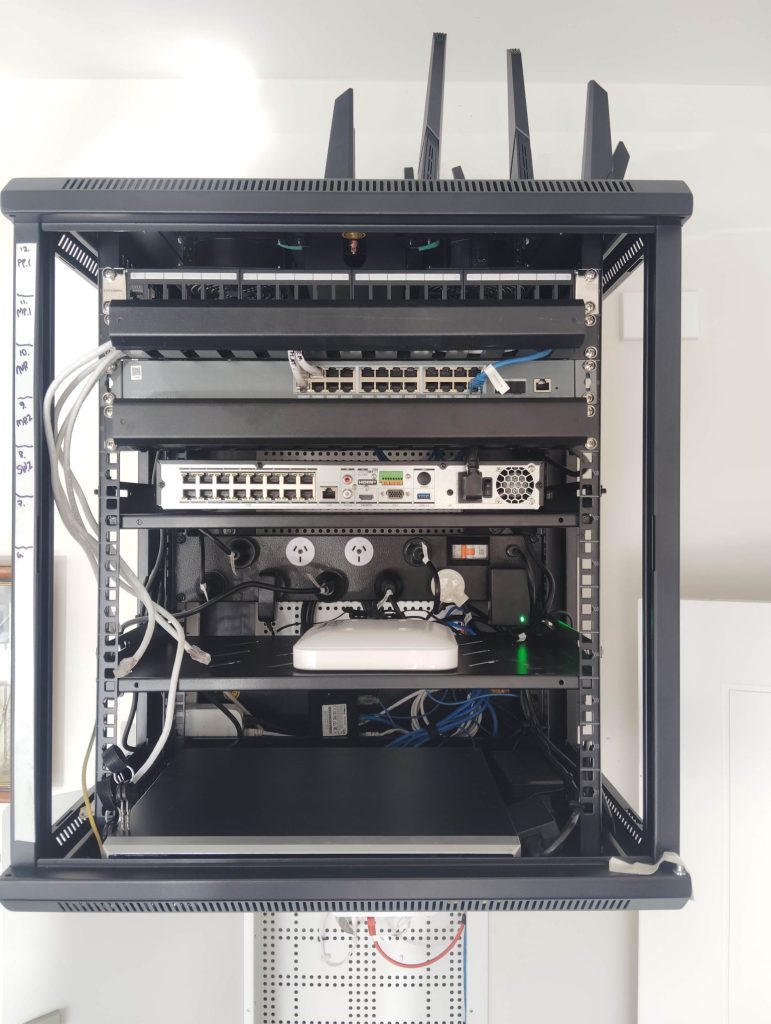 Wall-mounted network rack with router, switch and recorder